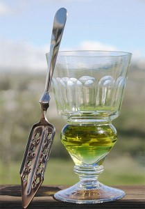 A glass of green absinth with special spoon
