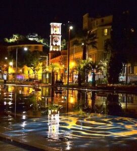The clocktower by night in Old Nice reflected in the water